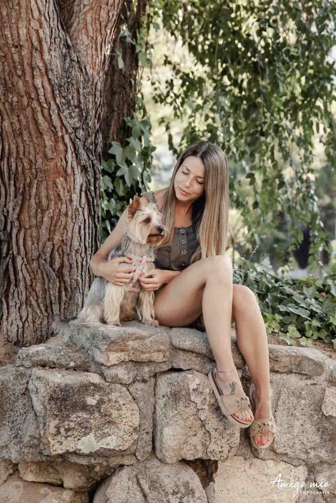 chica con su yorkshire terrier en un parque en exterior